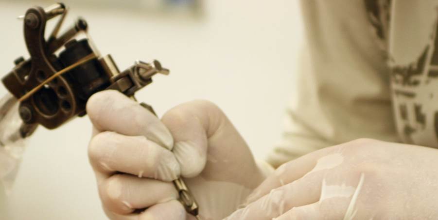 Close-up of a person's hands holding a machine

Description automatically generated